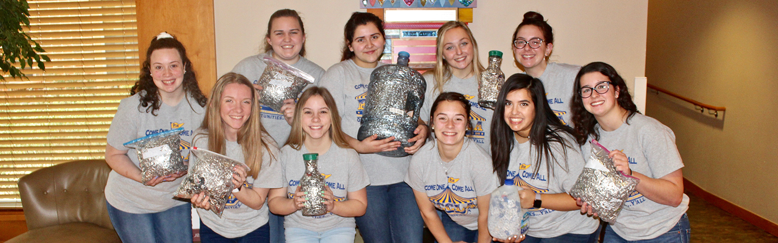 group of teens holds soda can pop tabs